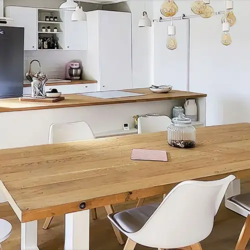 une cuisine avec une table, des chaises et un chiffon de table