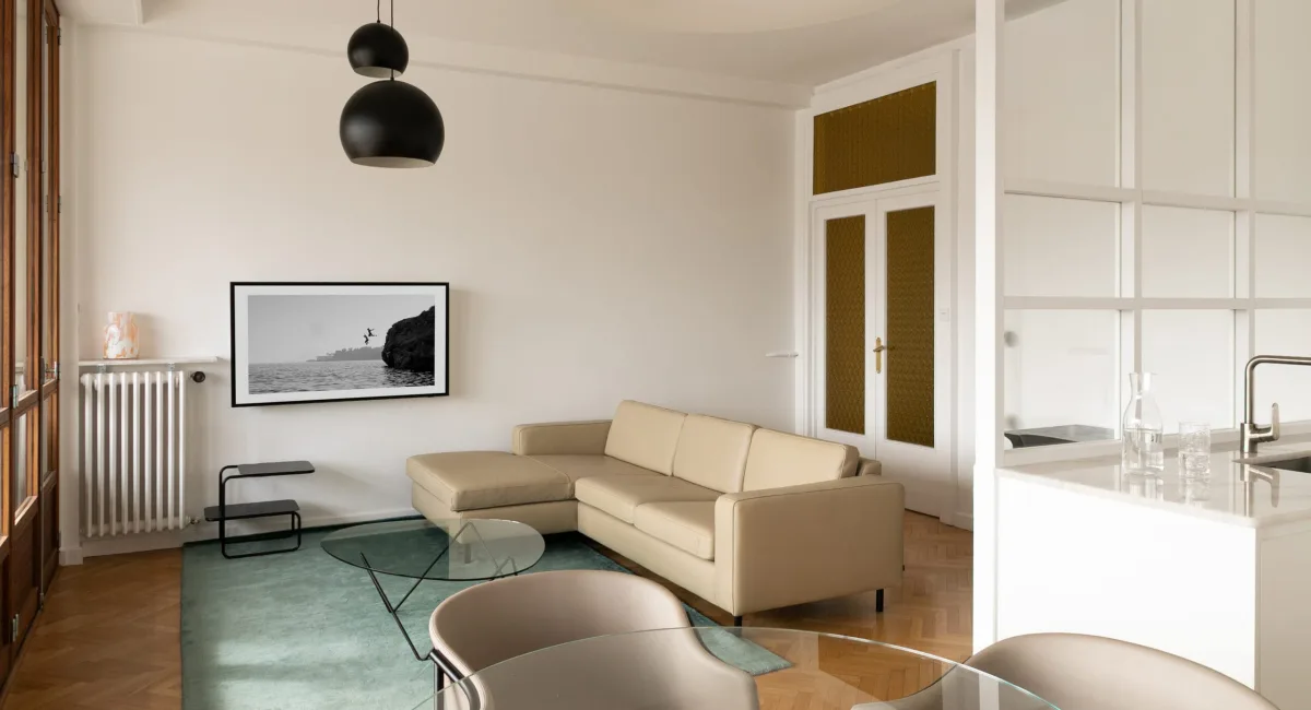 Intérieur moderne et épuré avec un canapé beige et une œuvre d'art.